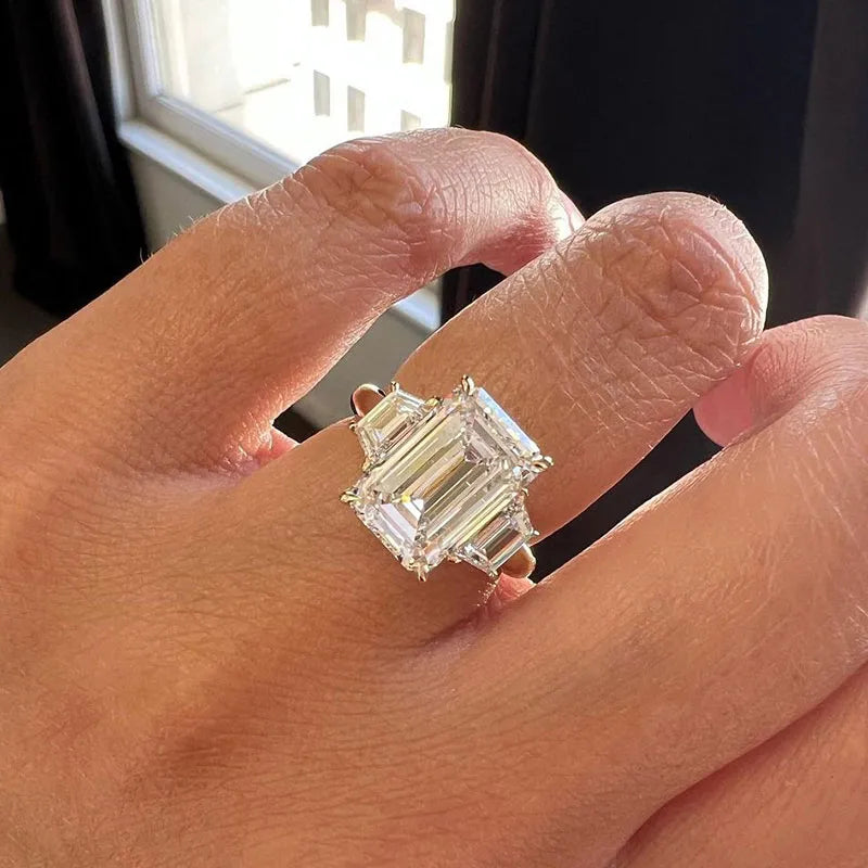 Lavish Emerald Cut 4.0ct Three Stone Engagement Ring In Sterling Silver