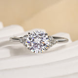 Ornate Solarii Moissanite 1.2ct Round Cut 925 Sterling Silver Side Stone Engagement Ring