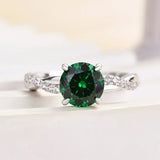 Timeless 1.25ct Twist Round Cut Emerald Green Engagement Ring In Sterling Silver