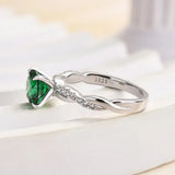 Timeless 1.25ct Twist Round Cut Emerald Green Engagement Ring In Sterling Silver