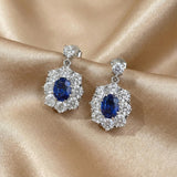 Solarii Oval Cut Blue Stone Halo Drop Earrings in Sterling Silver