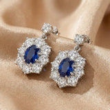 Solarii Oval Cut Blue Stone Halo Drop Earrings in Sterling Silver