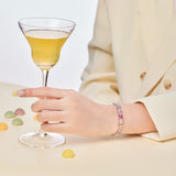 An Ethereal Trapezoidal Cut, Emerald Cut, and Round Cut Women's Bracelet adorned with Pink, White, and Yellow Stones