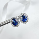 Dazzling Oval Cut Blue Stone Halo Sterling Silver Earrings